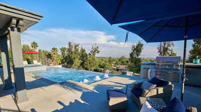 Relaxing pool area with red umbrellas Photo