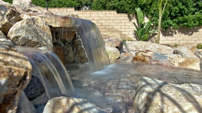 A rocky poolside waterfall. Photo