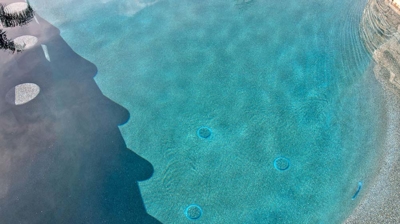 The interior of a pool with ripples and water. Photo