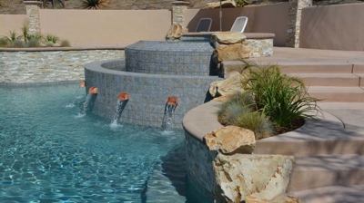 Verdant backyard haven with a pool, spa, and fire pit for ultimate relaxation. Photo