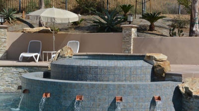 Backyard pool with a waterfall and spa. Photo