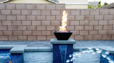 Backyard paradise boasting a generous pool accented by fire and water features. Photo