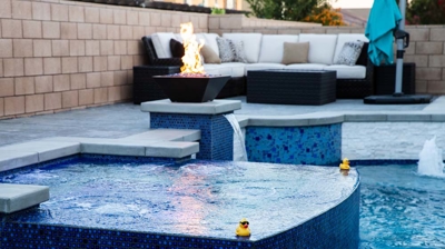 Exquisite backyard escape highlighting a sizable pool with vibrant blue tiles and a tranquil spa. Photo