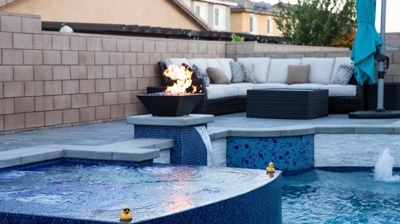 Captivating backyard sanctuary featuring a large pool adorned with vivid blue tiles and a calming spa. Photo