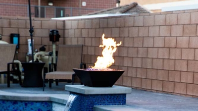 Gorgeous backyard landscape showcasing a sizable pool with striking blue tiles and a soothing spa. Photo