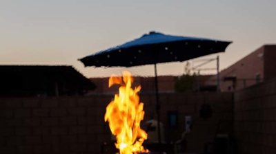 Inviting backyard haven with a large pool accented by captivating fire features and a relaxing spa. Photo