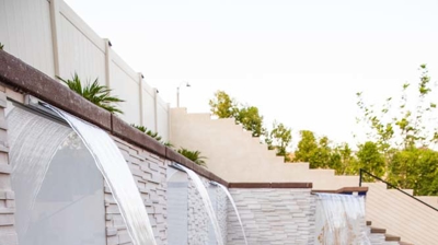 Aquatic paradise boasting in-ground pool, raised spa, and cascading waterfall. Photo