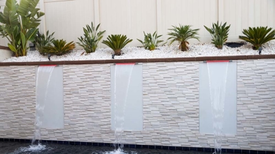 Aquatic refuge boasting in-ground pool, raised spa, and soothing waterfall. Photo