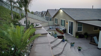 Outdoor haven with multi-level patio and thoughtfully landscaped grounds. Photo