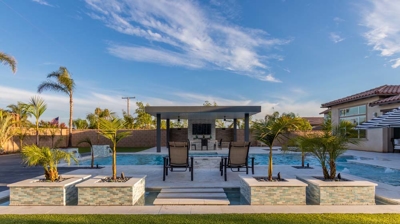 Sleek outdoor space includes modern pool and spa lounge area. Photo