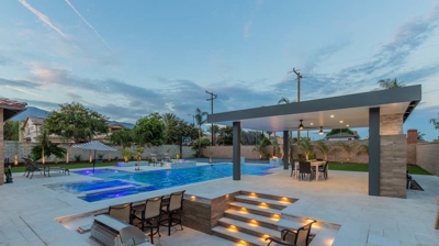 Contemporary backyard design: in-ground pool spa BBQ conversation area. Photo