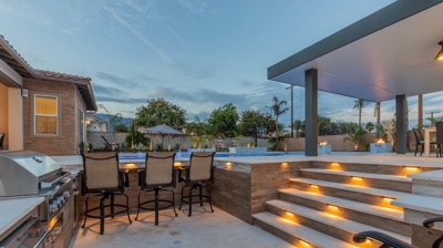 Contemporary outdoor haven boasts modern pool spa conversation lounge for BBQs. Photo