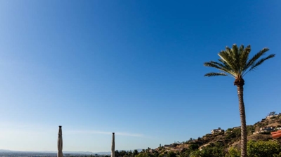 Classic Spanish architecture complemented by a fancy pool and cascading water features. Photo