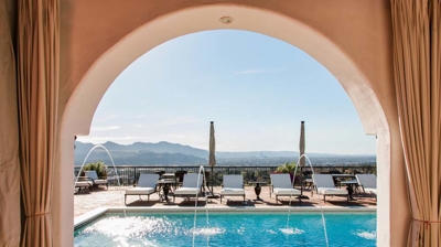 Magnificent Spanish villa boasting a fancy pool area with captivating water features. Photo