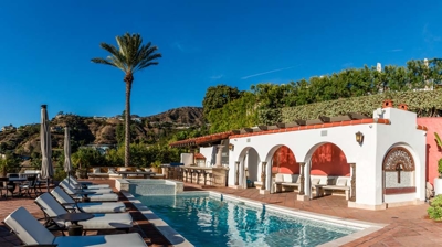 Spanish villa with a stunning pool adorned with elegant water features. Photo