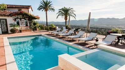 Stylish Mediterranean-inspired home featuring a sophisticated pool area with water elements. Photo