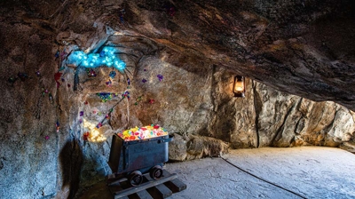A cave of wonder featuring fossilized marvels and embedded gem stones within its backyard walls. Photo