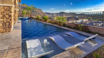 Lap pool and infinity edge spa with chaise lounges Photo