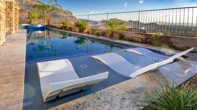 Lap pool and infinity edge spa with chaise lounges Photo