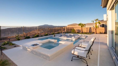 Backyard patio with pool, spa, and sunken seating area Photo