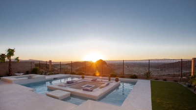 Sunken patio seating area in pool with view of desert Photo