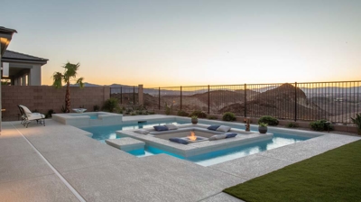 Backyard pool and patio with custom sunken seating area at sunset Photo