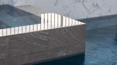 Stone infinity edge spa corner closeup Photo