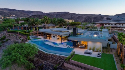 Aerial view of house with pool and patio area at sunset Photo