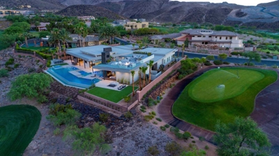 Aerial view of house with pool and patio area at sunset near golf course Photo