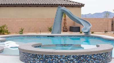 Backyard pool with custom spa and slide Photo