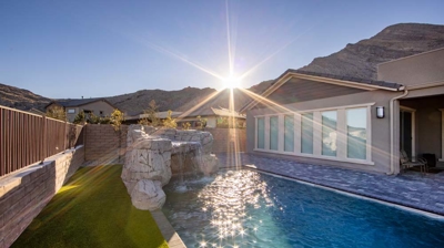 Backyard swimming pool with custom stone waterfall Photo