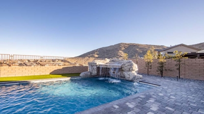 Swimming pool with custom stone waterfall Photo