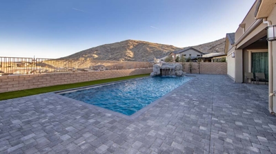 Swimming pool with custom waterfall and patio area Photo