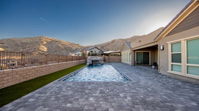 Backyard patio with view of pool Photo
