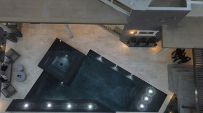 Aerial view of pool and patio area with custom lighting Photo