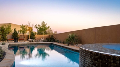 View of pool from infinity edge spa with custom tilework Photo