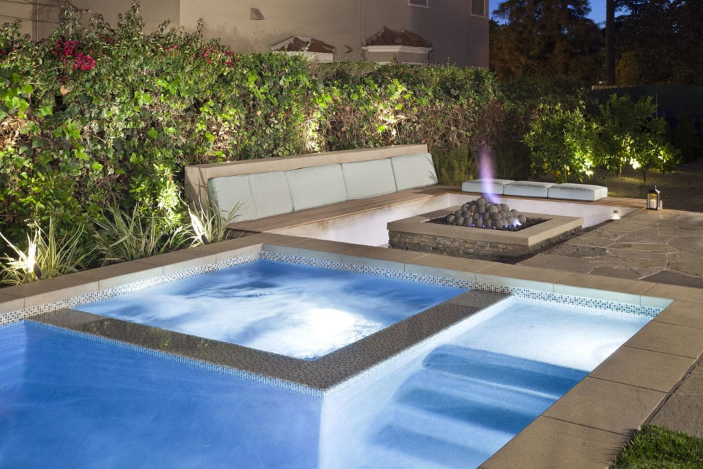 Contemporary pool and spa with a fire pit and patio seating