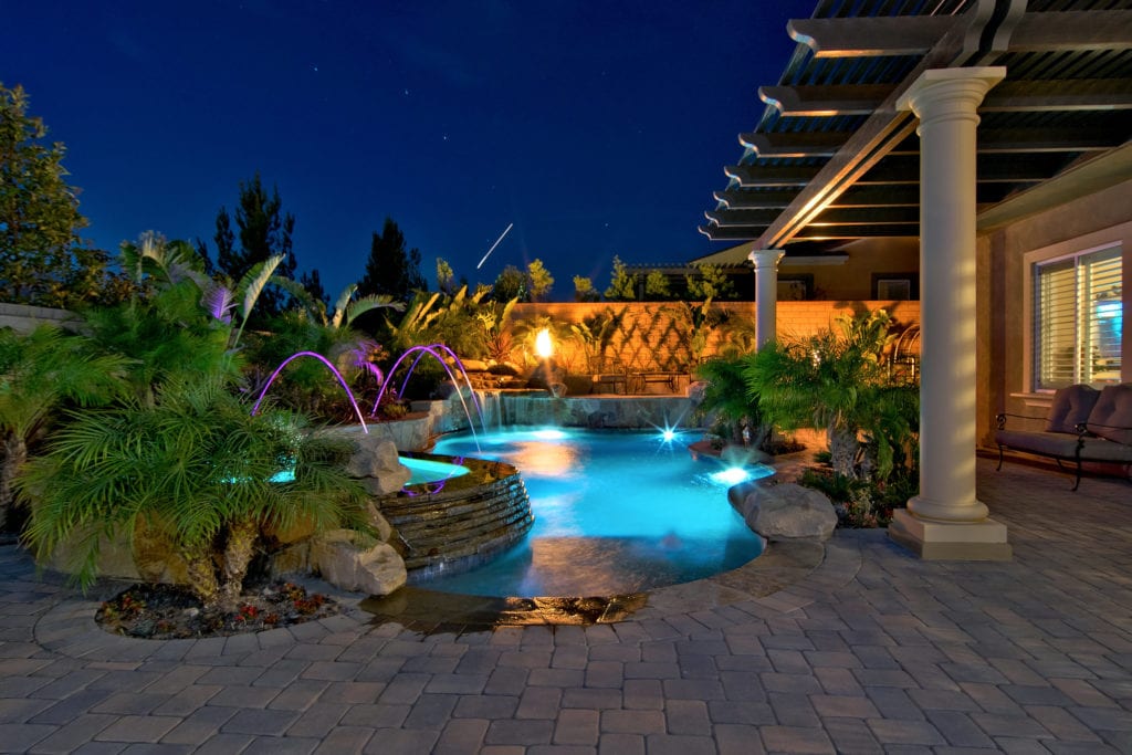 Evening photo of freeform swimming pool and spa