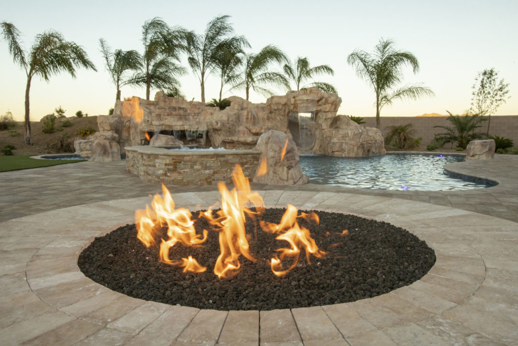 A pool with a floating fire pit