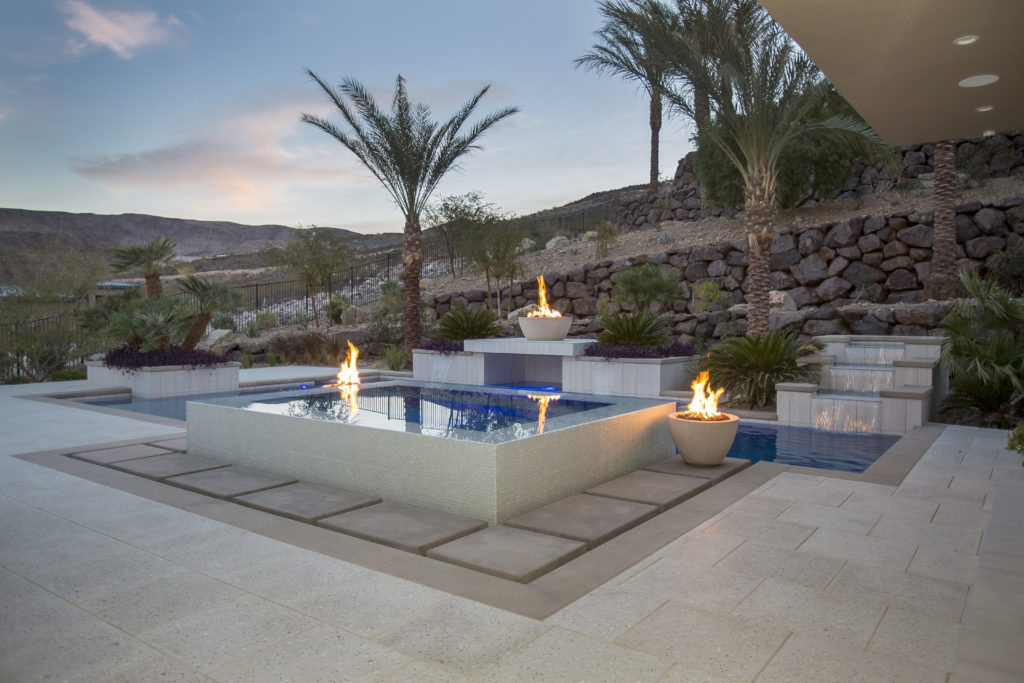 contemporary pool with elevated spa