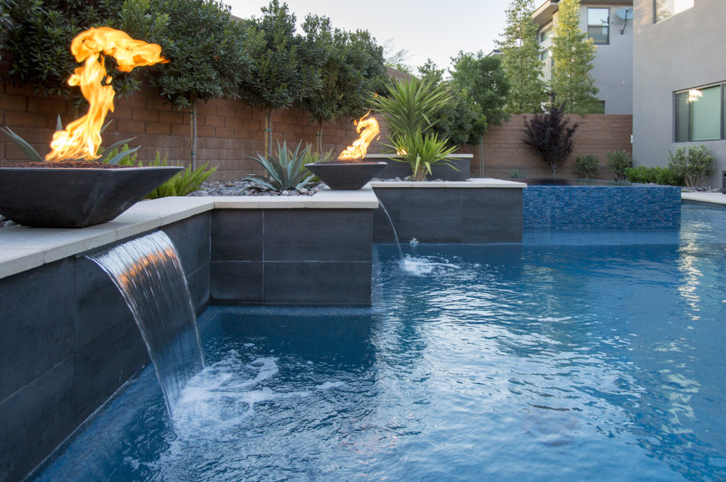 pool with fire bowls and waterfall